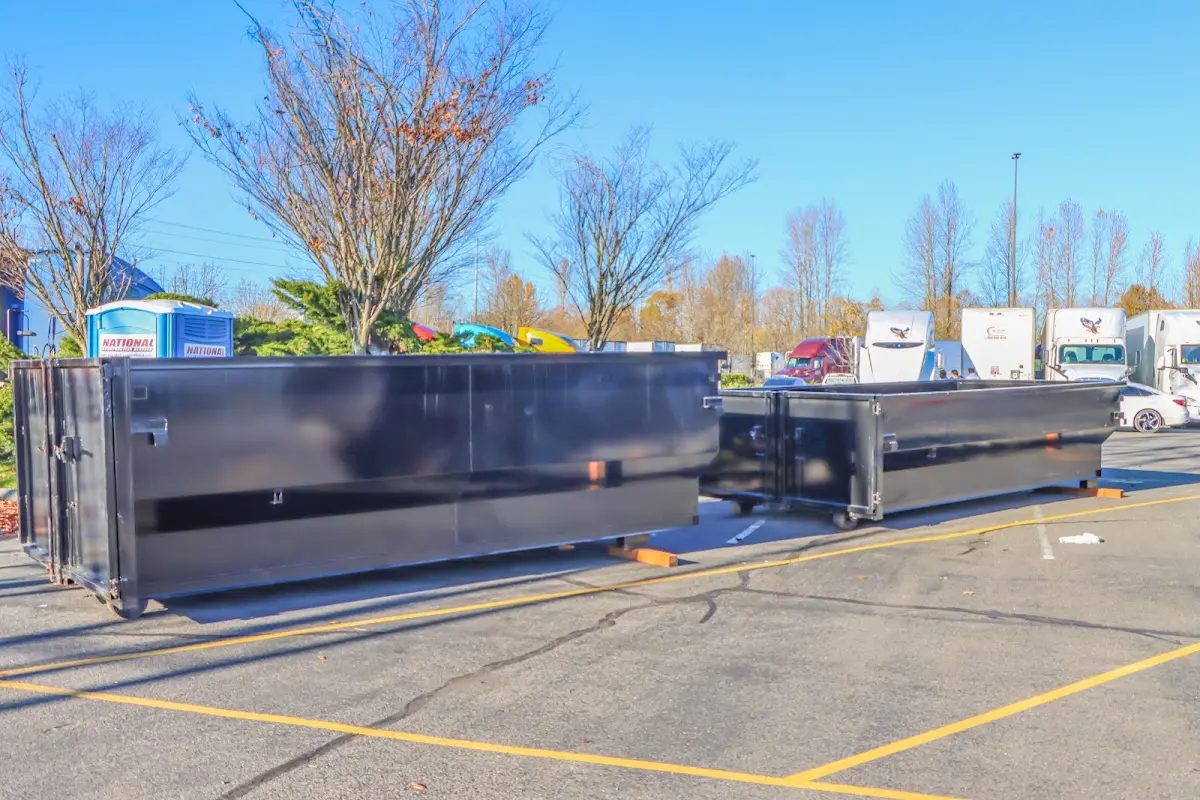 Professional dumpster rental service with roll-off container on residential driveway in Streamwood